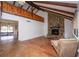 Inviting living room with stone fireplace, vaulted ceilings, and wood-look floors at 9916 Jackson Rd, Leesburg, FL 34788
