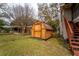 Backyard shed made of wood featuring a simple design and plenty of space for storage at 9916 Jackson Rd, Leesburg, FL 34788