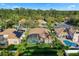 An aerial view of the property shows a well-maintained home with a screened-in pool and lush landscaping at 10986 Ledgement Ln, Windermere, FL 34786