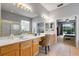 Bright bathroom features double sinks, bathtub and shower with glass door and a bedroom view at 10986 Ledgement Ln, Windermere, FL 34786