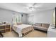 Bright bedroom features a cozy bed, couch and ample natural light, creating a relaxing and inviting space at 10986 Ledgement Ln, Windermere, FL 34786