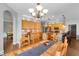 Open concept kitchen and dining room with wood table, chairs, cabinets, and stainless appliances at 10986 Ledgement Ln, Windermere, FL 34786