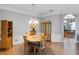 Well-lit dining room with wood table, chairs, and decorative cabinets at 10986 Ledgement Ln, Windermere, FL 34786