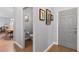 Inviting hallway featuring art, a grey front door, and a glimpse into a dining area, offering a warm welcome at 10986 Ledgement Ln, Windermere, FL 34786