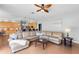 Open living room featuring hardwood floors, an adjacent kitchen, and lots of natural light at 10986 Ledgement Ln, Windermere, FL 34786