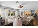 Spacious living room featuring hardwood floors, an open layout, and sliding glass doors to the patio at 10986 Ledgement Ln, Windermere, FL 34786