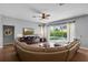 Open concept living room with hardwood floors, a ceiling fan, and a view of the pool at 10986 Ledgement Ln, Windermere, FL 34786