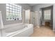 Bright main bathroom with a glass block window and a separate shower at 10986 Ledgement Ln, Windermere, FL 34786