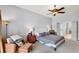 Cozy main bedroom with sitting area, ceiling fan and en-suite bathroom at 10986 Ledgement Ln, Windermere, FL 34786