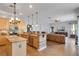 Open concept kitchen and living room with breakfast bar, stainless appliances, and wood flooring at 10986 Ledgement Ln, Windermere, FL 34786