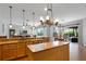 Open concept kitchen and living room with wood cabinets, stainless appliances, and tile floors at 10986 Ledgement Ln, Windermere, FL 34786