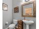 Stylish powder room with pedestal sink and decorative wall art at 10986 Ledgement Ln, Windermere, FL 34786
