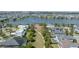 Aerial view of homes surrounding a lake with a walking path and green space at 13831 Briand Ave, Orlando, FL 32827