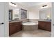 Inviting bathroom with a corner tub, dual sinks, decorative tile backsplash, and warm wood cabinets at 13831 Briand Ave, Orlando, FL 32827