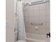Bathroom featuring a shower/tub combo with white tiles and a geometric patterned shower curtain at 13831 Briand Ave, Orlando, FL 32827