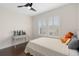 Bright bedroom with plantation shutters, a ceiling fan, neutral decor and desk at 13831 Briand Ave, Orlando, FL 32827