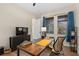 This room has hardwood floors, a large desk, and dark blue curtains at 13831 Briand Ave, Orlando, FL 32827
