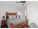Comfortable bedroom features a wood-framed bed, ceiling fan, and neutral walls at 13831 Briand Ave, Orlando, FL 32827