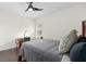 Cozy bedroom with work desk, ceiling fan, and window with wood shutters at 13831 Briand Ave, Orlando, FL 32827
