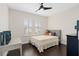 Bright bedroom with plantation shutters, a ceiling fan, and neutral decor with a gray padded headboard at 13831 Briand Ave, Orlando, FL 32827