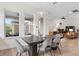 This dining area has stylish lighting and floor-to-ceiling windows with exterior views at 13831 Briand Ave, Orlando, FL 32827