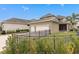This view showcases a two car garage and a large concrete driveway at 13831 Briand Ave, Orlando, FL 32827