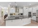 Modern kitchen features a large center island, stainless steel appliances, and white cabinetry at 13831 Briand Ave, Orlando, FL 32827