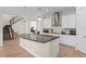 Modern kitchen with a large island, stainless steel appliances, and wooden floors at 13831 Briand Ave, Orlando, FL 32827