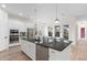This modern kitchen has a spacious island, stainless appliances, and a breakfast bar area at 13831 Briand Ave, Orlando, FL 32827