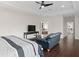 Spacious main bedroom boasts dark wood floors, tray ceiling, and sitting area with luxurious blue leather couch at 13831 Briand Ave, Orlando, FL 32827