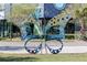 Outdoor art featuring a metal butterfly sculpture on a manicured lawn near a walking path at 13831 Briand Ave, Orlando, FL 32827