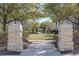 Inviting park entrance framed by stone pillars, leading to a serene green space at 13831 Briand Ave, Orlando, FL 32827