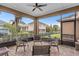 Relaxing screened-in patio with seating, outdoor views, and a ceiling fan at 13831 Briand Ave, Orlando, FL 32827