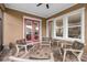 The screened-in patio offers seating, brick flooring, and views of the backyard at 13831 Briand Ave, Orlando, FL 32827