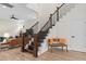 Staircase featuring wood steps, with metal balusters, next to a sitting area at 13831 Briand Ave, Orlando, FL 32827