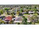 An aerial view of a neighborhood with tree-lined streets and well-maintained homes at 139 Acapulco Dr, Kissimmee, FL 34743