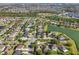 Drone view showcasing the neighborhood with beautiful lake views, lush greenery, and tree-lined streets at 1502 Fern Bay Ct, Orlando, FL 32824