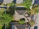 Aerial view of the property highlighting the roofline, surrounding trees, and proximity to the neighborhood streets at 1502 Fern Bay Ct, Orlando, FL 32824