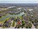 Drone shot of the neighborhood featuring a home with views of a scenic lake and lush green landscapes at 1502 Fern Bay Ct, Orlando, FL 32824