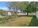 Large grassy backyard area with mature trees, providing plenty of space for outdoor activities and relaxation at 1502 Fern Bay Ct, Orlando, FL 32824