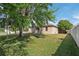 Expansive backyard showcasing lush green grass, mature trees, and an inviting outdoor space for recreation at 1502 Fern Bay Ct, Orlando, FL 32824