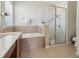 The bathroom features double sinks, soaking tub and glass enclosed shower with tile surround at 1502 Fern Bay Ct, Orlando, FL 32824