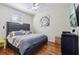 Bedroom features a ceiling fan, wood floors and decorative art hanging on the wall at 1502 Fern Bay Ct, Orlando, FL 32824