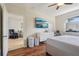 This bedroom features wood floors, white dresser and a large television on the wall at 1502 Fern Bay Ct, Orlando, FL 32824