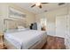This bedroom features wood floors, ceiling fan, decorative headboard and artwork above the bed at 1502 Fern Bay Ct, Orlando, FL 32824