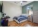 A bedroom featuring wood floors, desk, bed and large window at 1502 Fern Bay Ct, Orlando, FL 32824