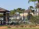 Relax poolside surrounded by palm trees in a tranquil community swimming pool at 1502 Fern Bay Ct, Orlando, FL 32824