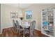 Charming dining room with a silver table, stylish chairs, and built-in shelving at 1502 Fern Bay Ct, Orlando, FL 32824
