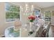 Bright dining area featuring a chandelier, decorative table setting, and hardwood floors at 1502 Fern Bay Ct, Orlando, FL 32824