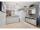 Modern kitchen featuring bar seating, updated appliances, and a view to a hallway and entrance at 1502 Fern Bay Ct, Orlando, FL 32824